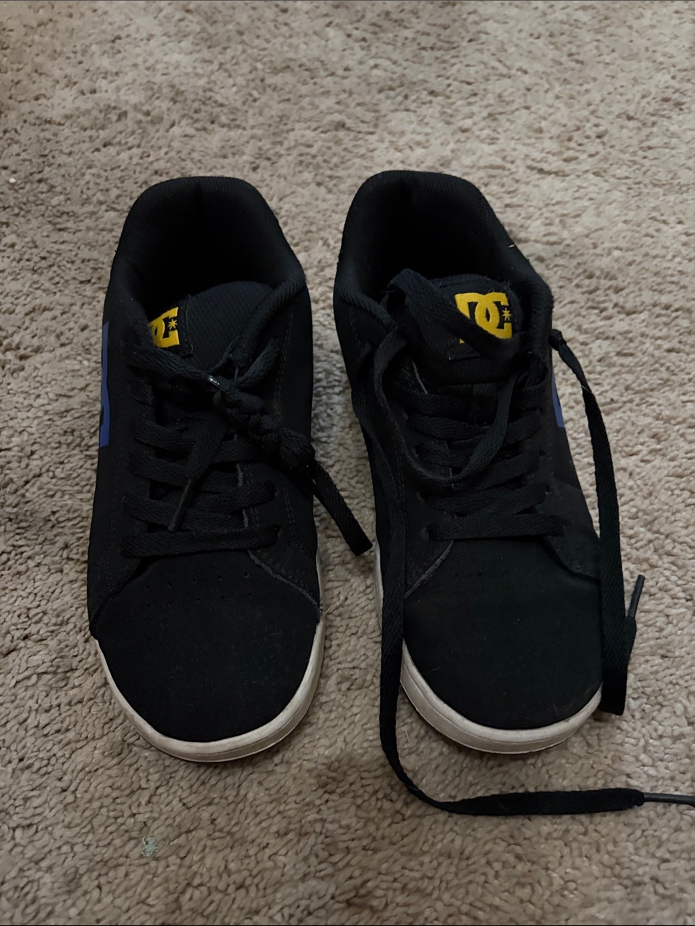 DC Black Low-Top Skate Shoes with Yellow Logo and Blue Accent